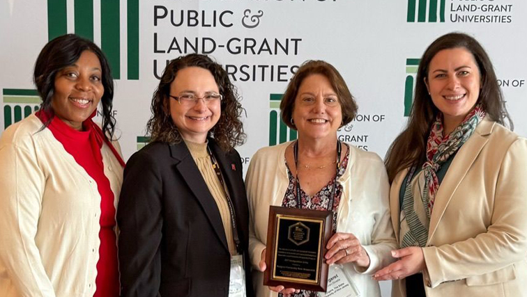 Photo of Rutgers staffers with APLU award